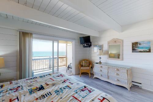 a bedroom with a bed and a balcony with the ocean at Sea Splash 2 in Ocean City