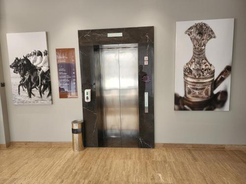 a elevator in a room with a vase on the wall at Citadines Al Ghubrah Muscat in Muscat