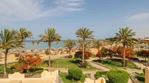 a view of a resort with palm trees and the ocean at Blend Elphistone Resort Marsa Alam in Abu Dabab