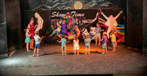 a group of children standing on a stage in front of a performance at Blend Elphistone Resort Marsa Alam in Abu Dabab