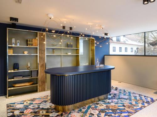 a bar in a room with a blue wall at Hotel Čad in Ljubljana