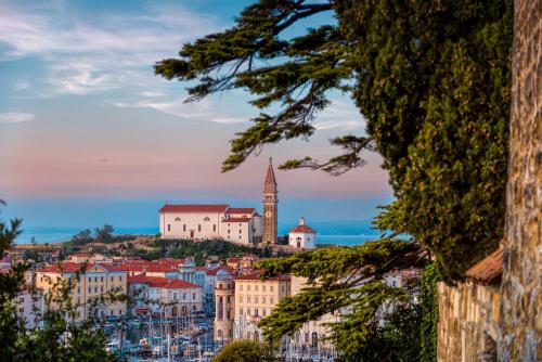 a view of a city with a clock tower at Piranum Guesthouse in Piran