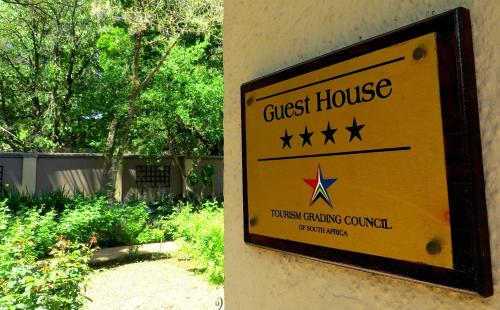 a guest house sign on the side of a building at Bordeaux Haven Guest House in Vereeniging