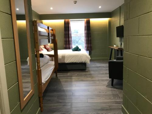 a room with two bunk beds and a window at Rostrevor Mountain Lodge - Glamping Pods - Revive Sauna & Hot Tubs in Rostrevor