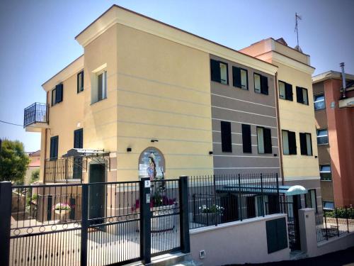 a building with a fence in front of it at Floridida Rooms & Breakfast in Marina di Andora