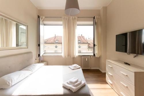 A bed or beds in a room at Via Torino Apartment 2