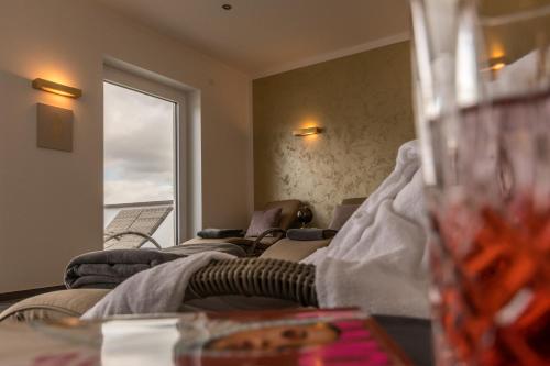 a living room with two couches and a window at Waldhotel zum Bergsee Damme in Damme