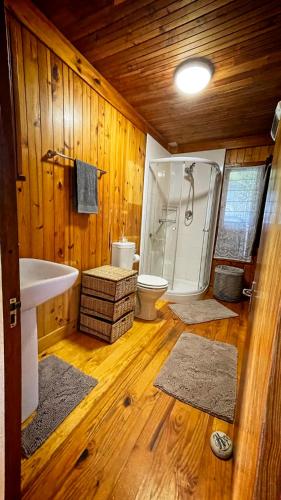 a bathroom with a tub and a shower and a toilet at 16 Dune Park in Keurboomstrand