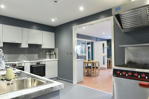 a kitchen with a sink and a stove at Rostrevor Mountain Lodge - Glamping Pods - Revive Sauna & Hot Tubs in Rostrevor