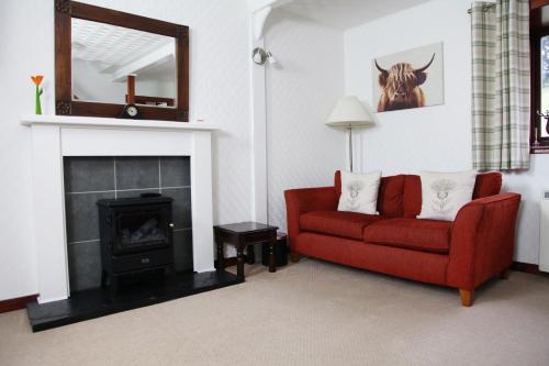 a living room filled with furniture and a fire place at Ardgarry Farm in Invergarry