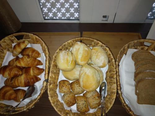 
a table topped with different types of baked goods at Hotel Jardim Viana do Castelo in Viana do Castelo
