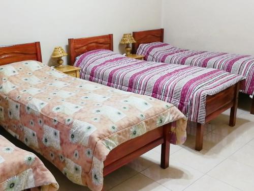 a group of three beds in a room at Tierra Nuestra in Tarija