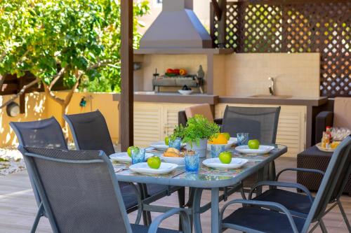 a table with plates of food on a patio at Protaras Villa Angela Nefeli in Paralimni
