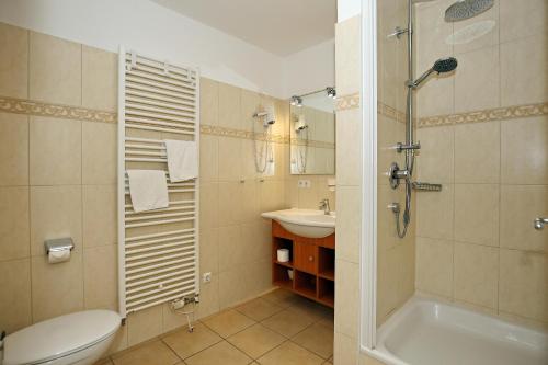a bathroom with a toilet and a sink and a shower at Dünenschloss Wohnung 2-11 in Kühlungsborn