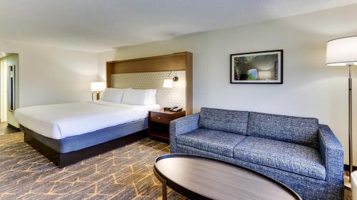 a hotel room with a bed and a couch at Holiday Inn Staunton Conference Center by IHG in Staunton