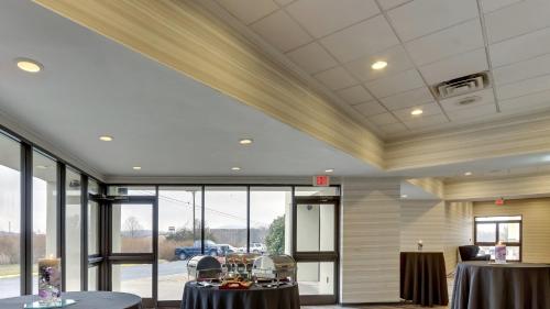 a large room with two tables and large windows at Holiday Inn Staunton Conference Center by IHG in Staunton