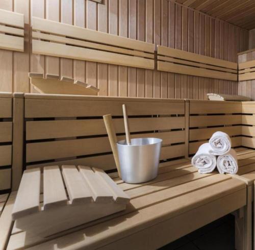 a sauna with a bench and rolled towels on it at Hotel Schloss Schweinsburg in Neukirchen-Pleiße