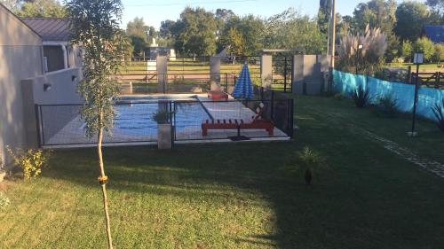a backyard with a pool with a bench next to it at Un lugar en Monte in San Miguel del Monte