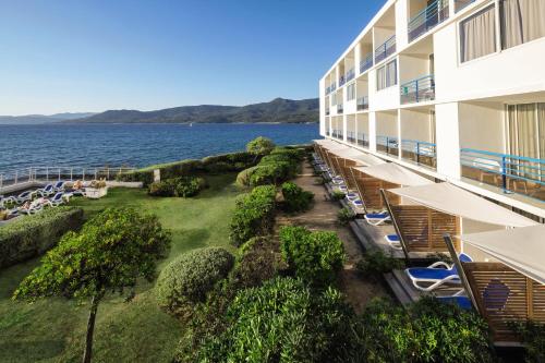 a view of the ocean from the balcony of a hotel at Hôtel Propriano Arena Bianca in Propriano