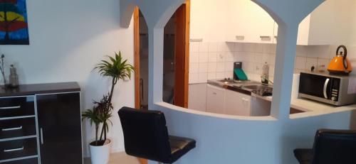 a kitchen with a black chair and a sink at Monteurswohnungen in Kirchhain zentral in Kirchhain