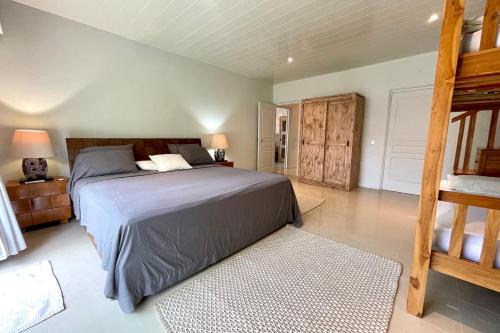 a bedroom with a large bed and a ladder at Villa Maramatea vast modern and comfy leisure and chill out in Moorea in Vaianae