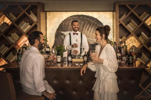 a bride and groom standing at a bar at Monte Mulini Adults Exclusive Hotel by Maistra Collection in Rovinj