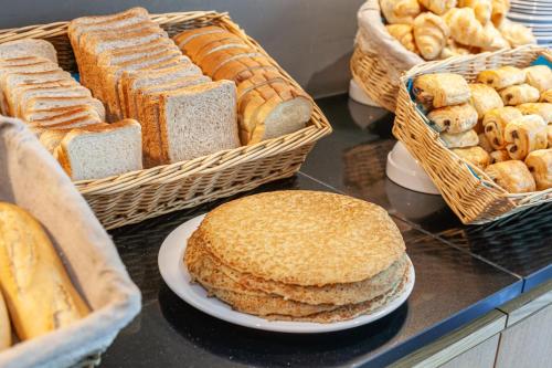 a display of bread and pastries on a counter at Residhotel Le Grand Prado in Marseille