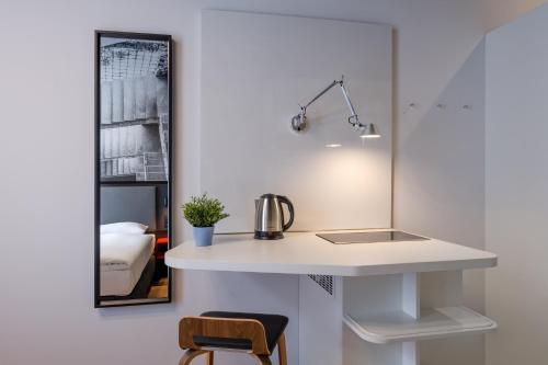 a kitchen with a white counter and a sink at Dean's Home Budapest in Budapest