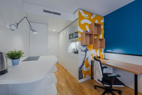 an office with a desk and a blue wall at Dean's Home Budapest in Budapest