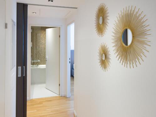 a hallway with two mirrors on a wall at RAFAEL KAISER - Premium Apartments City Centre - Contactless Check-In in Vienna