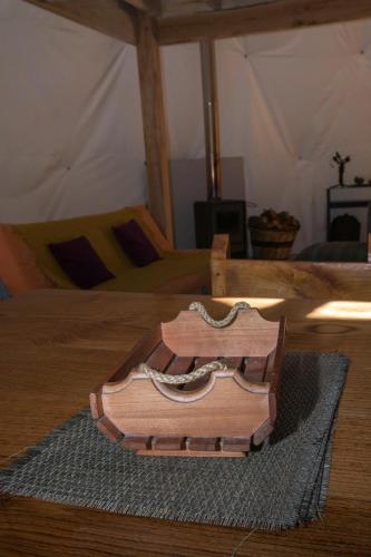 a wooden suitcase sitting on top of a bed at Cabañas Ensenada Bosque Nativo in Ensenada