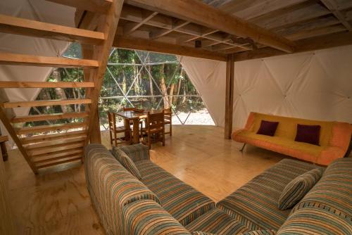 a living room with a couch and a table at Cabañas Ensenada Bosque Nativo in Ensenada