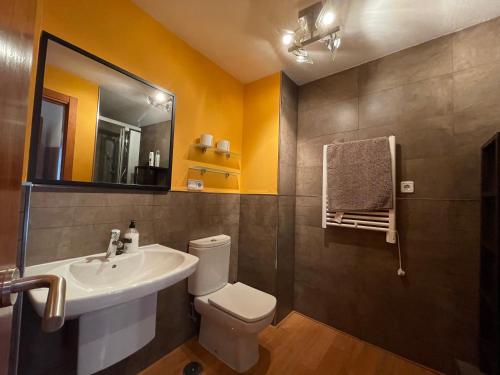 a bathroom with a sink and a toilet and a mirror at Palacio Santa Ursula in Toledo