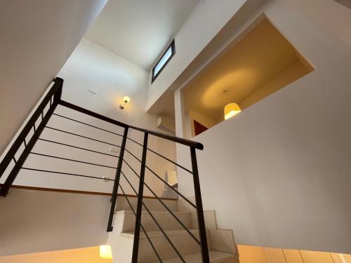a spiral staircase in a house with a window at Palacio Santa Ursula in Toledo