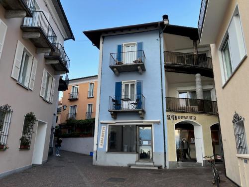a blue building with two balconies on a street at Ascona: CÀ DAL DOLZ in Ascona