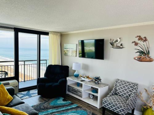 a living room with a view of the ocean at 1602 Coastal Soul Pet friendly in Myrtle Beach
