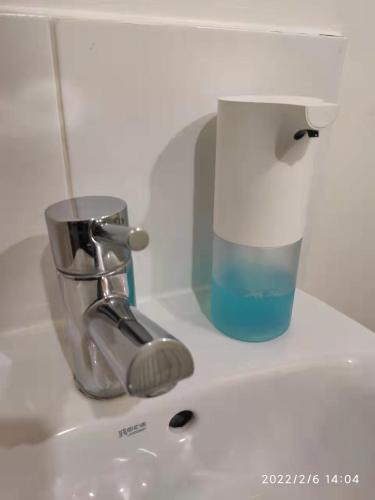 a sink with a faucet and a cup on it at City Centre duplex 3rooms apartment with parking in Nottingham