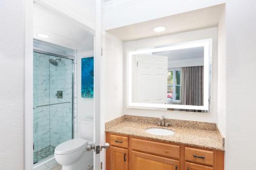 a bathroom with a sink and a toilet and a mirror at Gorgeous Condo Near Disney in Orlando