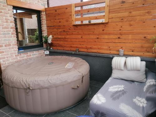 a hot tub and a bean bag chair in front of a building at Bulles d étoiles in Beloeil