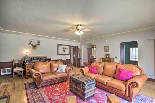 a living room with leather furniture and a ceiling fan at Remote Escape Riverside Home with Scenic Views in Idanha