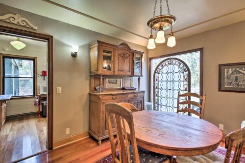 a kitchen and dining room with a wooden table and chairs at Remote Escape Riverside Home with Scenic Views in Idanha