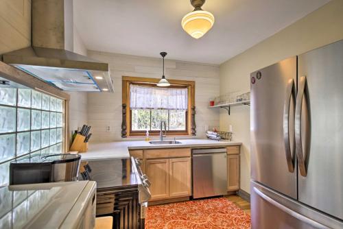 a kitchen with a stainless steel refrigerator and a window at Remote Escape Riverside Home with Scenic Views in Idanha