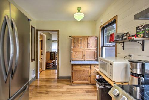 a kitchen with a refrigerator and a microwave at Remote Escape Riverside Home with Scenic Views in Idanha