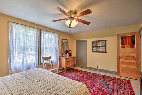 a bedroom with a bed and a ceiling fan at Remote Escape Riverside Home with Scenic Views in Idanha