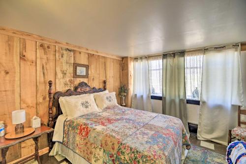 a bedroom with a bed in a room with wooden walls at Unique ATV Apartment in Remodeled Schoolhouse in Gary