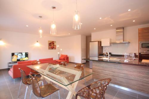 a kitchen and living room with a table and chairs at Residence Catherine in Calvi