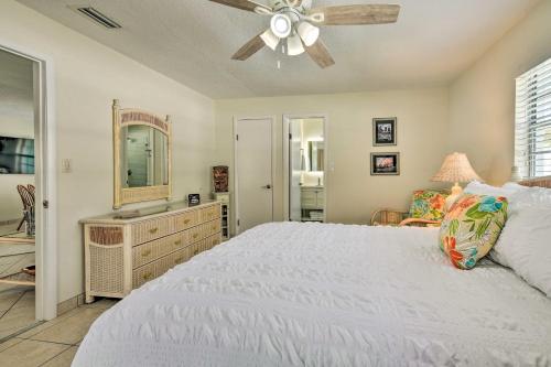 a bedroom with a white bed and a ceiling fan at Apollo Beach Gem with Pool The Flamingo House in Apollo Beach