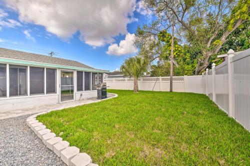 a house with a fence and a yard at Apollo Beach Gem with Pool The Flamingo House in Apollo Beach