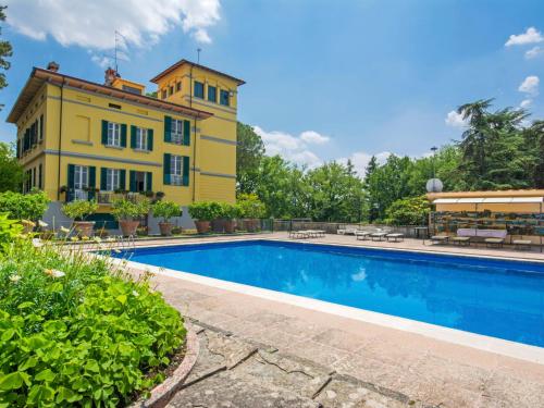 a house with a swimming pool in front of a building at Villa Poggio Patrignone-1 by Interhome in Campoluci