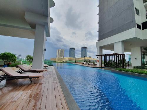 a swimming pool on the roof of a building at Southkey Mosaic Mid Valley Johor Bahru in Johor Bahru